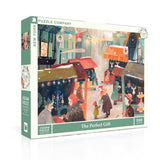 Jigsaw puzzle box with a festive street scene design on a white background