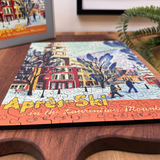 Jigsaw puzzle with 'Après Ski' design on a wooden surface