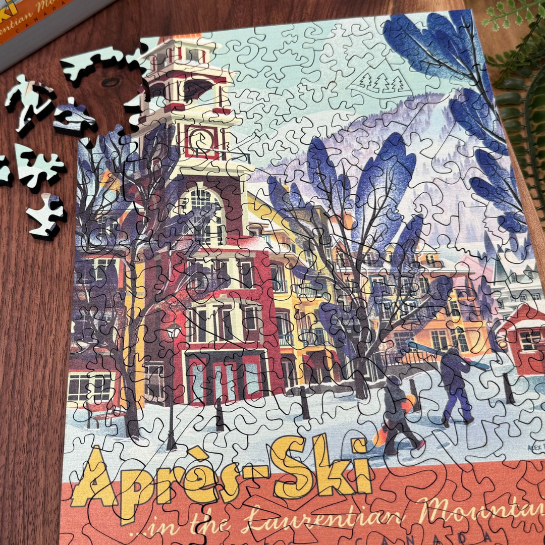 Jigsaw puzzle with a completed section featuring a snowy scene with trees and buildings, labeled 'Après-Ski in the Laurentian Mountains'.
