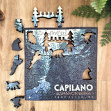 Wooden puzzle of Capilano Suspension Bridge with animals on a wooden surface