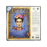 The back cover of a puzzle box featuring Frida Kahlo's iconic portrait in a blue and gold Mexican folk art style, with orange butterflies and Spanish text on the right side.