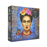 A 1000-piece jigsaw puzzle box by Paperblank, featuring a stylized portrait of Frida Kahlo with orange and pink flowers in her hair, set against a blue and gold ornate background.