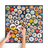Person assembling a puzzle with vintage-style buttons on a blue background