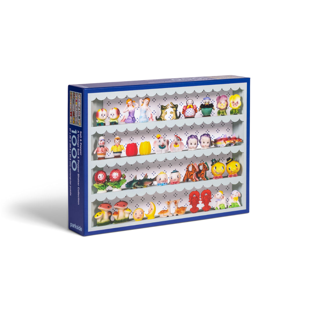 Jigsaw puzzle box of small vintage figurine salt and pepper shakers with a blue border on a white background