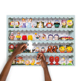 Image of small figurine salt and pepper shakers with a hand reaching for a piece on a white background