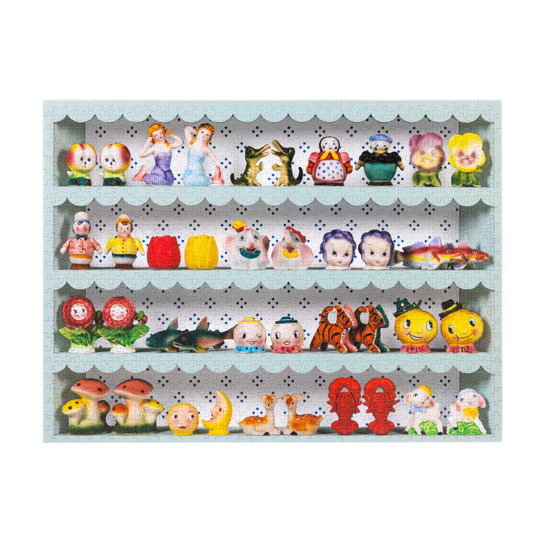 jigsaw puzzle of a shelf with various small  vintage salt and pepper shaker figurines on a light blue shelf 