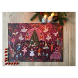 Decorative Christmas-themed placemat with colorful designs on a wooden surface.