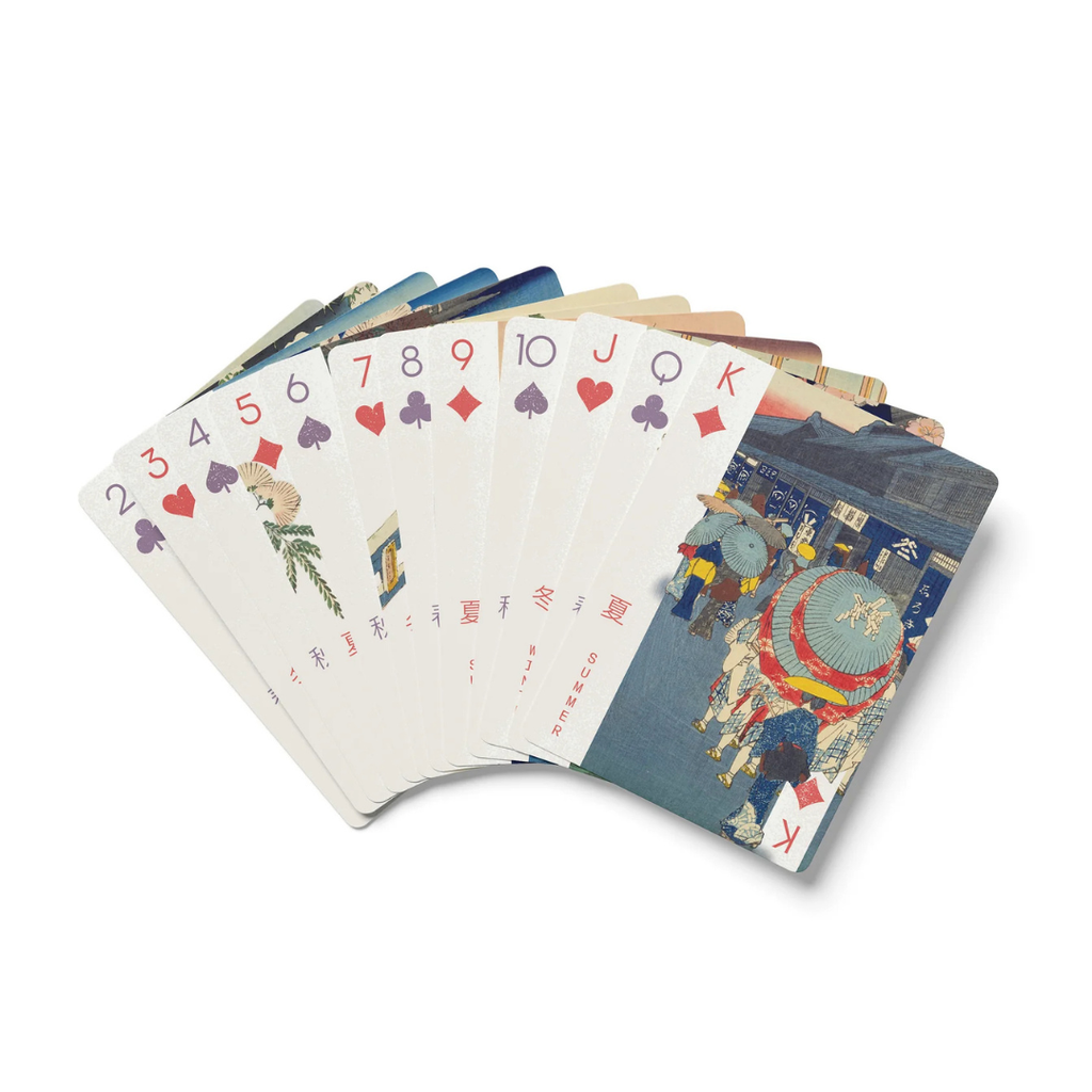 Set of playing cards with colorful designs on a white background