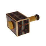 Wooden toy puzzle box with hieroglyphic designs on a white background