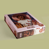 Puzzle box with a woman's face on a green background