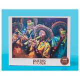 Jigsaw puzzle box featuring three musicians with conga drums on a blue background, branded 'Puzzles of Color'.