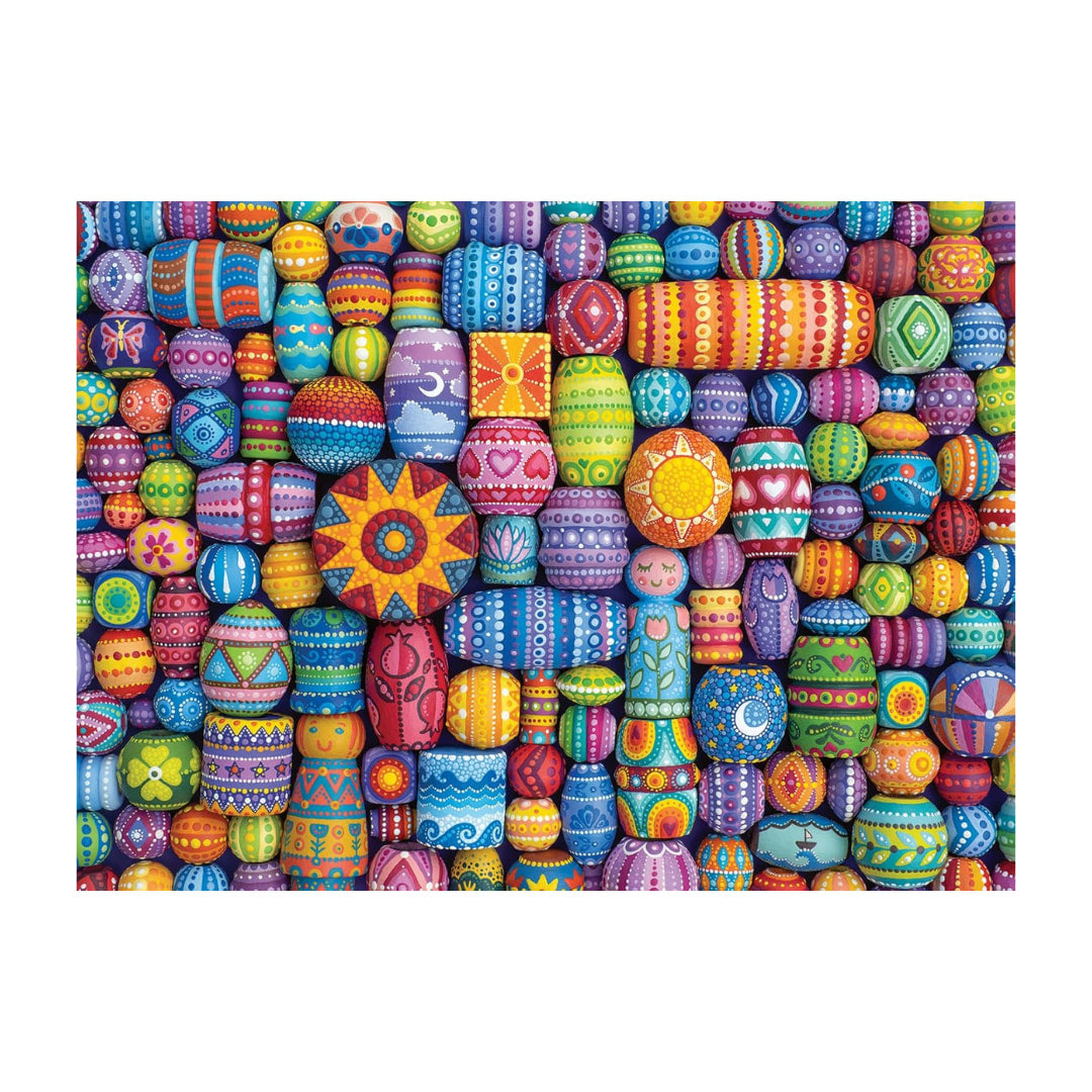 Colorful patterned beads arranged in a decorative design on a white background