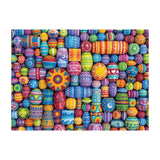 Colorful patterned beads arranged in a decorative design on a white background