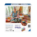 Ravensburger puzzle box featuring a woman reading a book with a colorful interior setting.