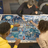 Three people working on a large puzzle together at a table.