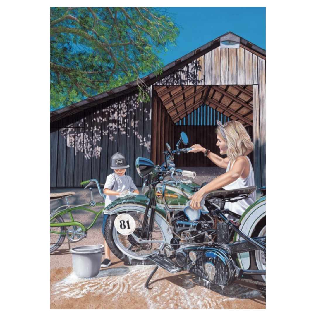 Woman and child with a vintage motorcycle in front of a wooden shed.