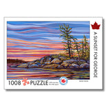 Jigsaw puzzle packaging with a sunset over water and trees design, featuring the artist Wendy Wood.
