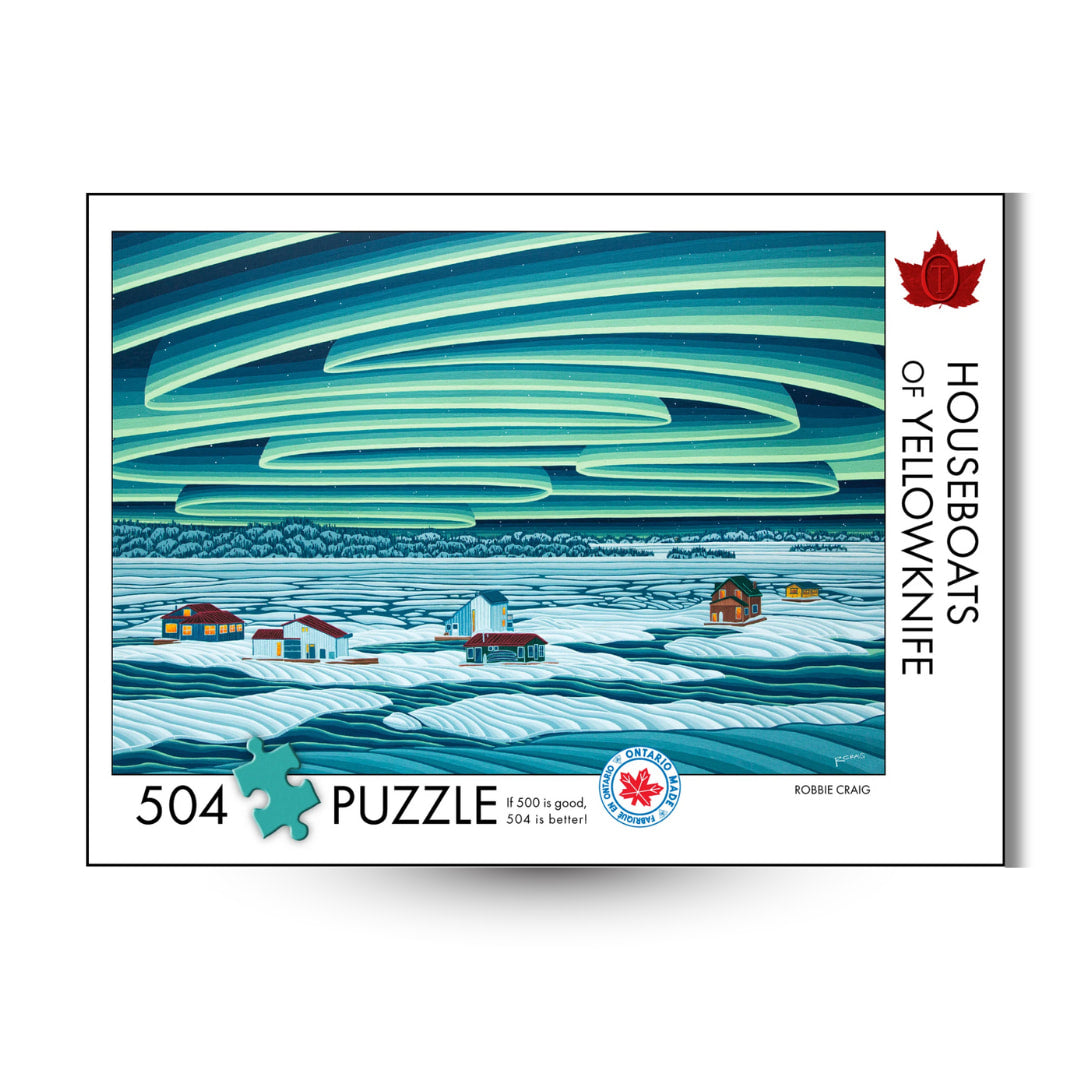 Puzzle box with a scenic illustration of houseboats on water and a stylized sky, featuring the title 'Houseboats of Yellowknife' by Robbie Craig.