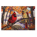 Two cardinals on a branch with autumn foliage and a lake in the background
