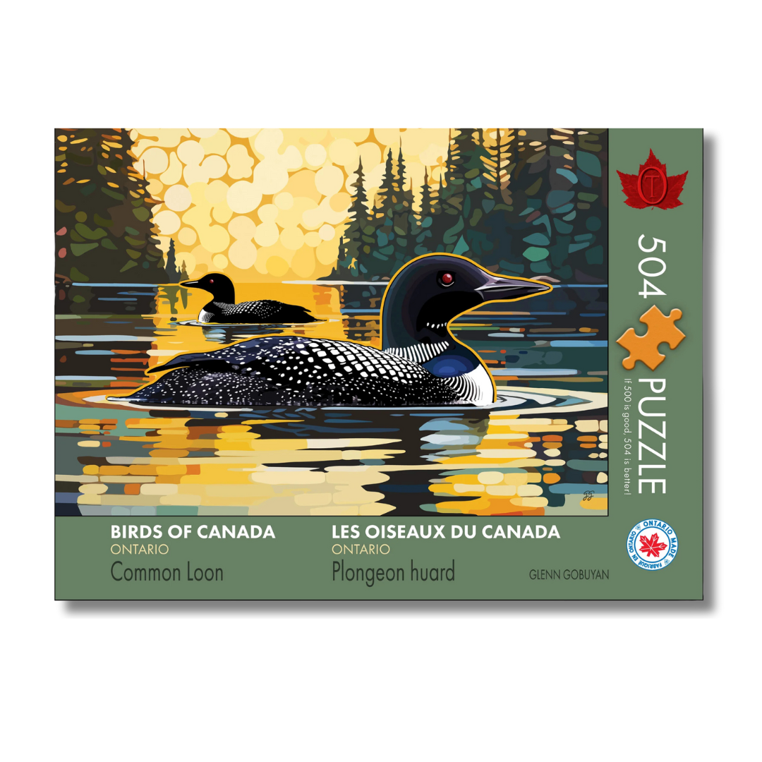 Jigsaw puzzle box featuring a Common Loon on a lake with a sunset background, labeled 'Birds of Canada'.