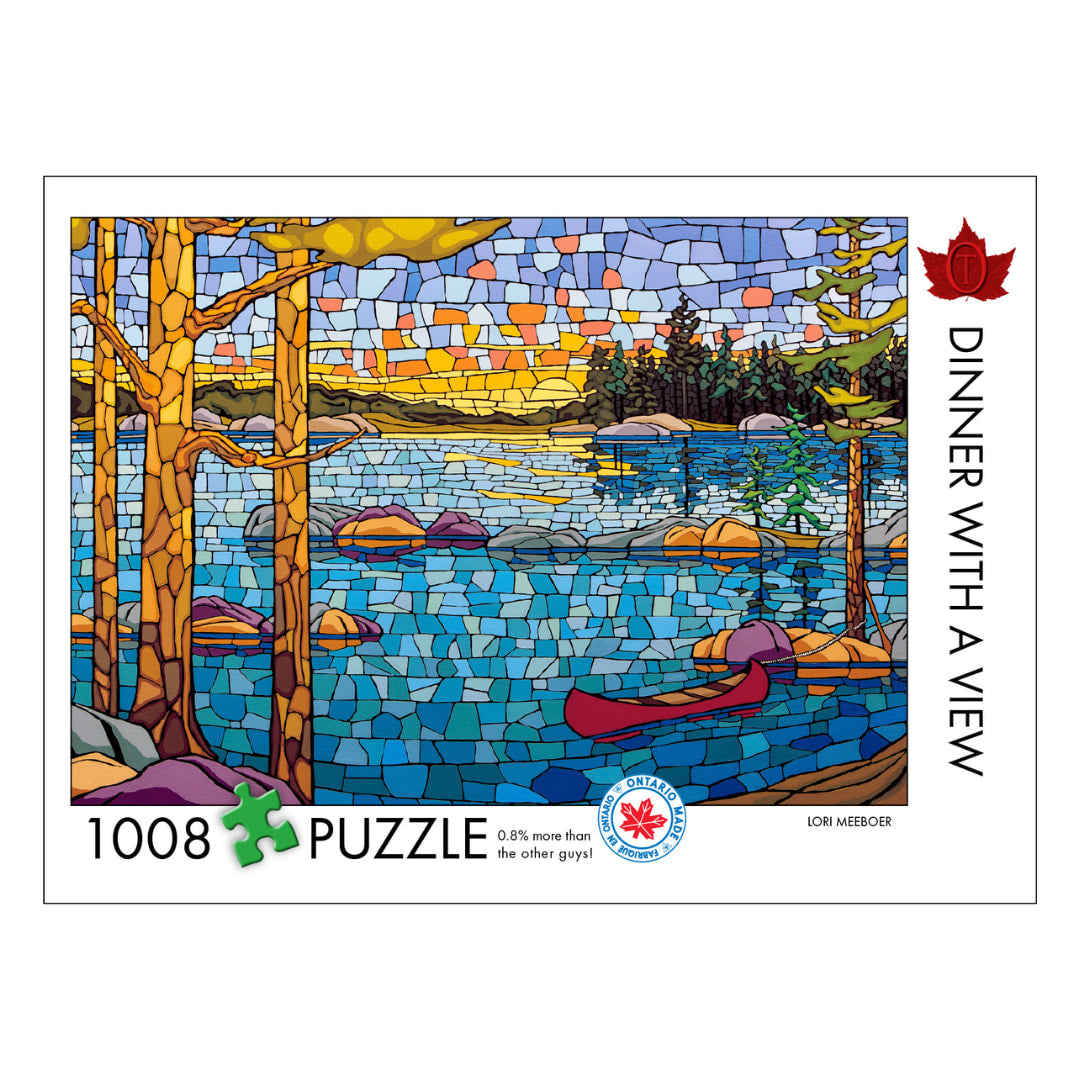 Jigsaw puzzle packaging with a lake and trees design, featuring a red maple leaf.