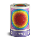 A cylindrical puzzle box with a colorful concentric circle design in red, orange, yellow, green, blue, and purple on a white background.