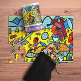 Colorful puzzle with a partially completed design on a wooden surface, accompanied by a black drawstring bag.