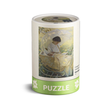 Puzzle box with artwork of a woman in a wicker chair on a white background