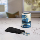Puzzle packaging with mountain design on a marble surface