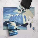 Jigsaw puzzle with mountain design on a marble surface