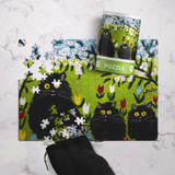 Jigsaw puzzle with black cat design on a white surface