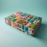 Colorful patterned jigsaw puzzle box on a teal background
