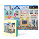 Puzzle box with a colorful illustration of a seaside town scene on the cover