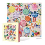 A 1000-piece jigsaw puzzle and its box featuring a colorful beach scene with striped umbrellas, sun loungers, beachgoers, and a pale beige background. The brand name 'Werkshoppe' is visible on the box.