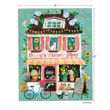 A completed jigsaw puzzle featuring a whimsical illustration of Daisy's Flower Shop, with flowers, a blue bicycle, and an open sign, shown on a white background with 8 by 10 inch dimension markers.
