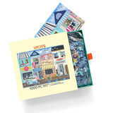 Puzzle packaging with a colorful illustration of a town scene and a partially completed puzzle inside.