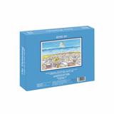 Jigsaw puzzle box with a scenic illustration on a blue background