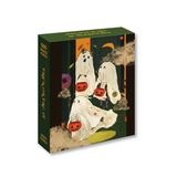 A 500-piece jigsaw puzzle box titled 'Trick Or Treat' with a dark green cover featuring a whimsical illustration of ghosts in white robes holding jack-o'-lanterns, set against a plain white background.
