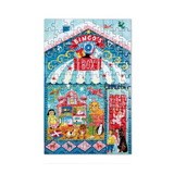 A completed jigsaw puzzle featuring a colorful circus or fairground scene with a large 'BINGO BOX' sign, striped arch, animals, and playful figures, shown on a plain white background.