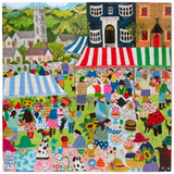 A colorful, highly detailed jigsaw puzzle depicting a lively village market scene with people, tents, houses, and various objects, featuring the text 'THE BULL INN' on a building.