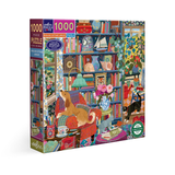 A 1000-piece jigsaw puzzle box by eeBoo, featuring a highly detailed, colorful illustration of a cozy book-filled room with cats and a dog. The box is shown at a three-quarter angle against a plain white background.