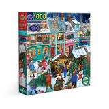 A 1000-piece jigsaw puzzle box by eeBoo, featuring a colorful winter village scene with snow-covered rooftops, glowing storefronts, people, trees, and festive decorations. The box is shown at a slight angle against a plain white background.