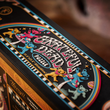 Close-up of a Grateful Dead-themed jigsaw puzzle box featuring colorful Grateful Dead bear illustrations and the text 'Grateful Dead Puzzle' on a black background.