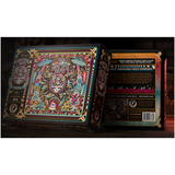 The  Grateful Dead multi-dimensional jigsaw puzzle box by theory 11, featuring an intricate, colorful gothic illustration of a skull and decorative elements on the front, with the back panel visible on the right.