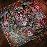 A Grateful Dead jigsaw puzzle featuring the iconic 'Sleepwalker' design, partially assembled and photographed from an overhead angle on a dark wooden floor.