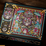 Grateful Dead 1000-piece jigsaw puzzle in its illustrated black box, photographed on a dark wooden surface. The box features highly detailed, colorful Grateful Dead artwork with skulls, dancers, and psychedelic motifs.