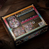 Grateful Dead jigsaw puzzle box shown from the back on a dark wooden surface, featuring colorful artwork, product details, and a barcode.