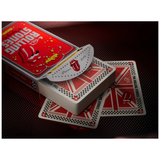 A boxed deck of Rolling Stones-themed playing cards with several cards fanned out on a dark red textured surface. The packaging features the red and white Rolling Stones logo and text, and the card backs repeat the red, white, and black checkered design.