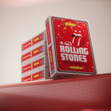 A stack of red and white playing cards featuring The Rolling Stones artwork, displayed on a textured red surface against a plain light background.