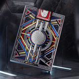 A Star Trek themed playing card deck standing upright on a display stand. The box features a highly detailed, colorful illustration of the Starship Enterprise ship with geometric borders in red, blue, yellow, and silver, and a Star Trek insignia at the top.